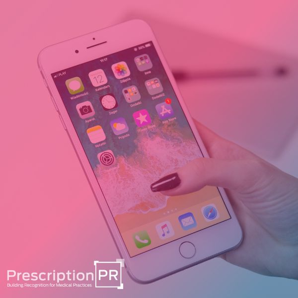A woman holding an iPhone displaying a healthcare app with the text "prescription pr," showcasing how medical apps are changing the way people manage their healthcare.